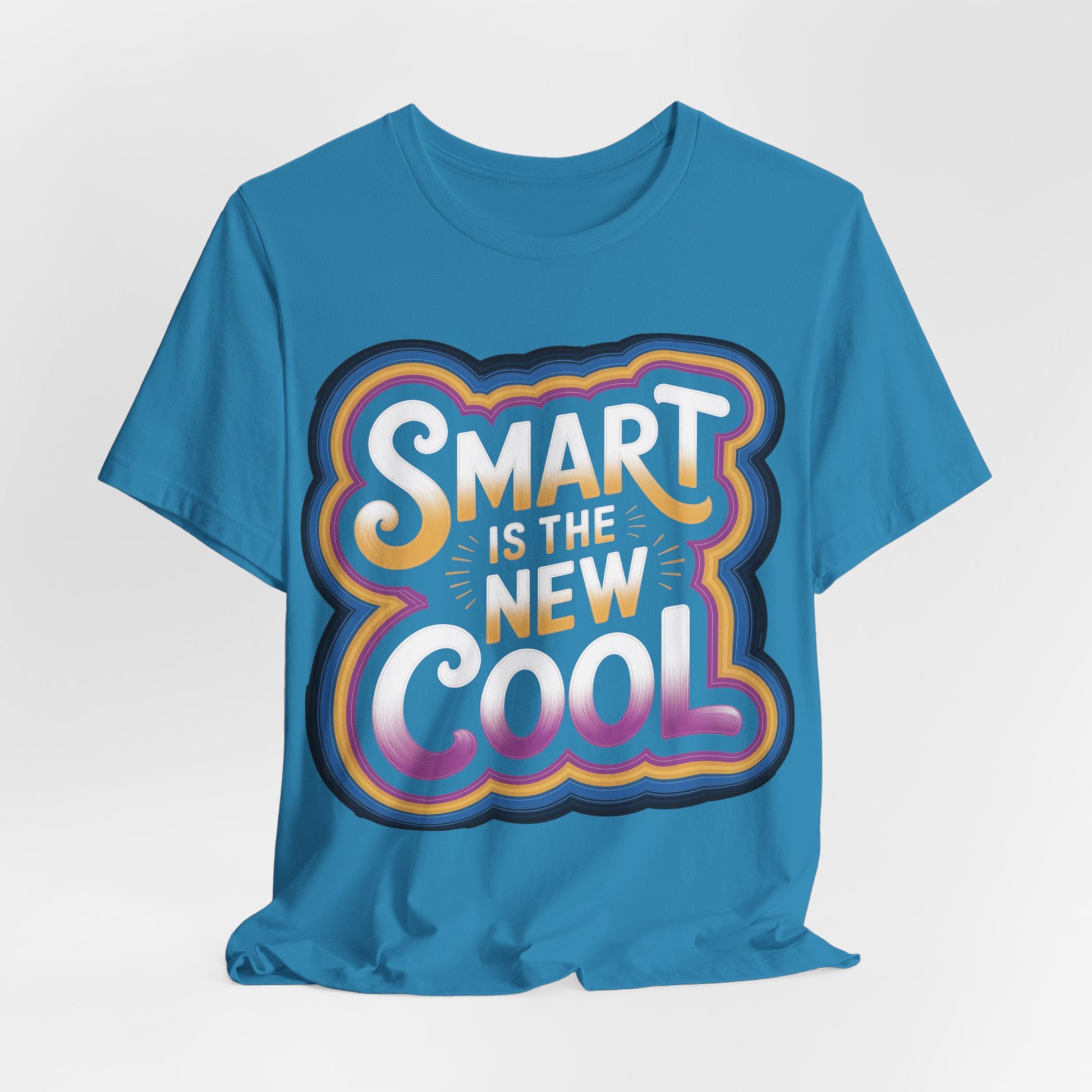 Back-to-school graphic tee featuring the slogan 'Smart Is the New Cool' in vibrant colors on a aqua blue background.